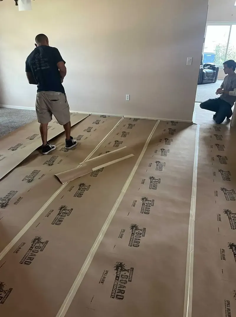 Crew measuring a protected floor before installation