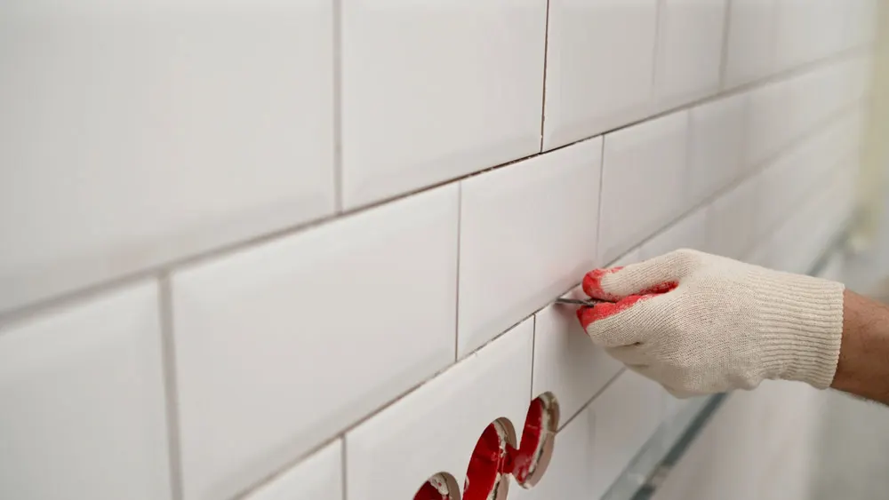 Grout cleaning contractor working on subway tile