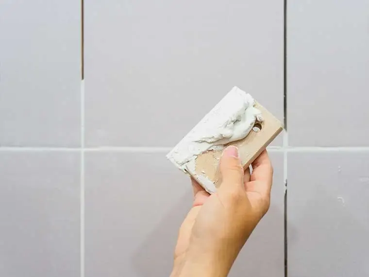 Grouting large white wall tile