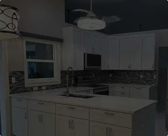 Kitchen replacement with white cabinets and dark counters