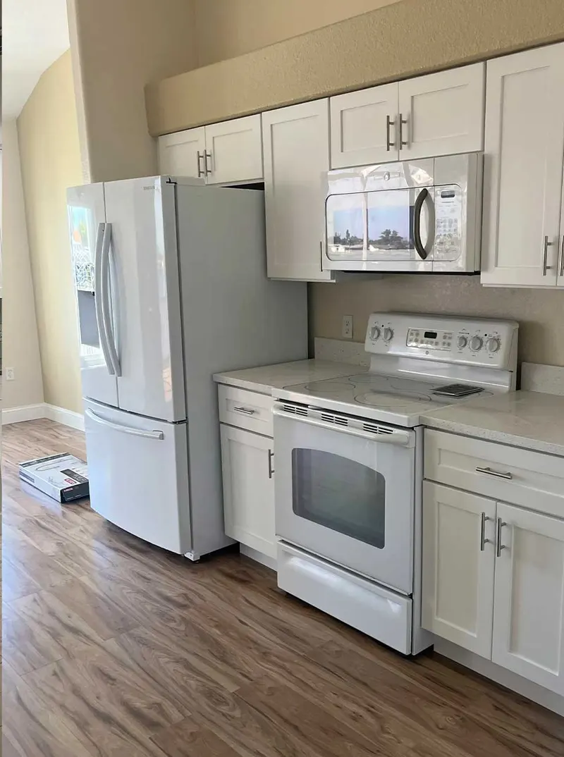 Remodeled kitchen with white cabinetry