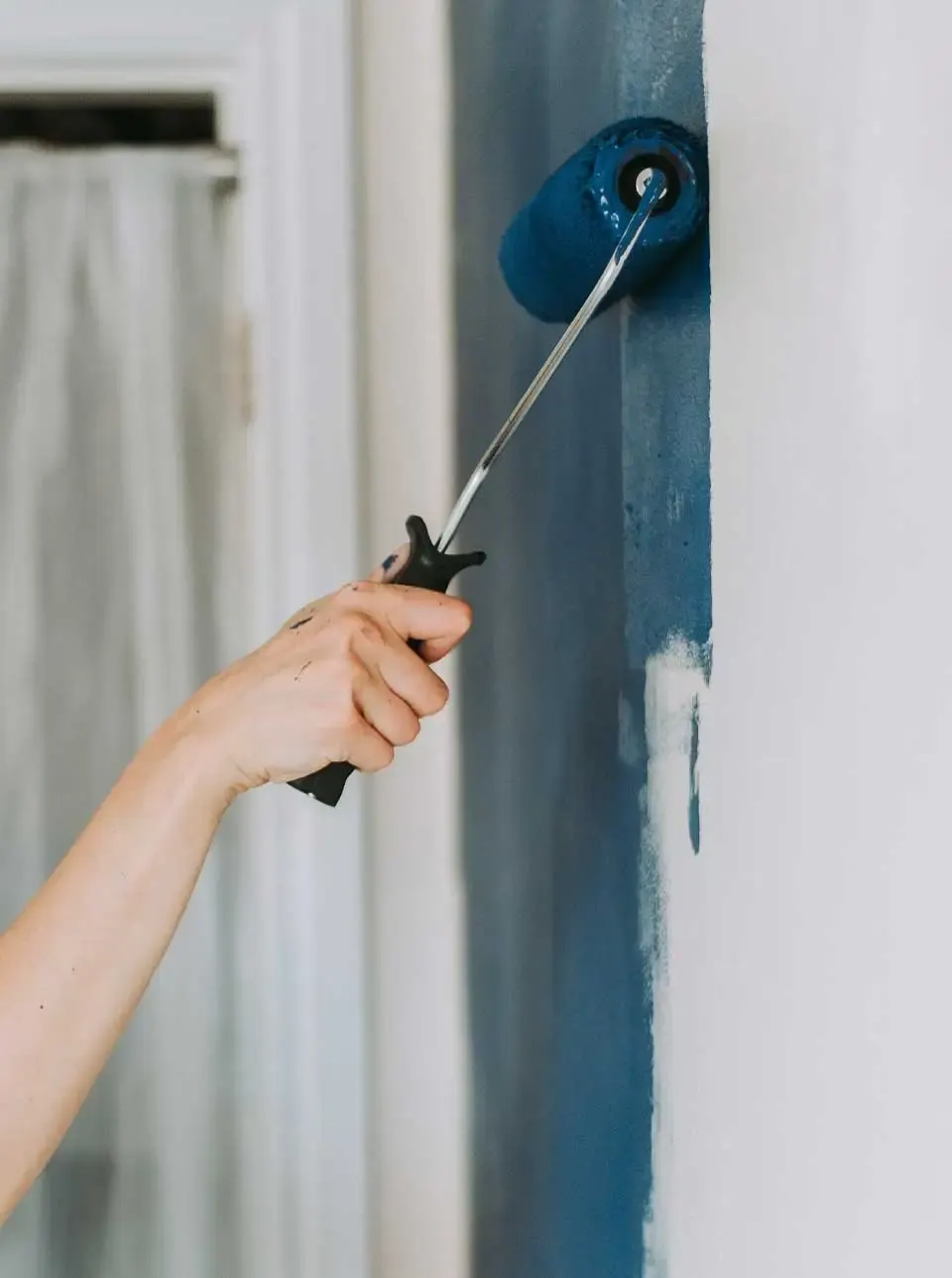 Rolling paint onto an interior wall