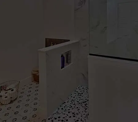 Shower curb and patterned mosaic floor during a bathroom renovation