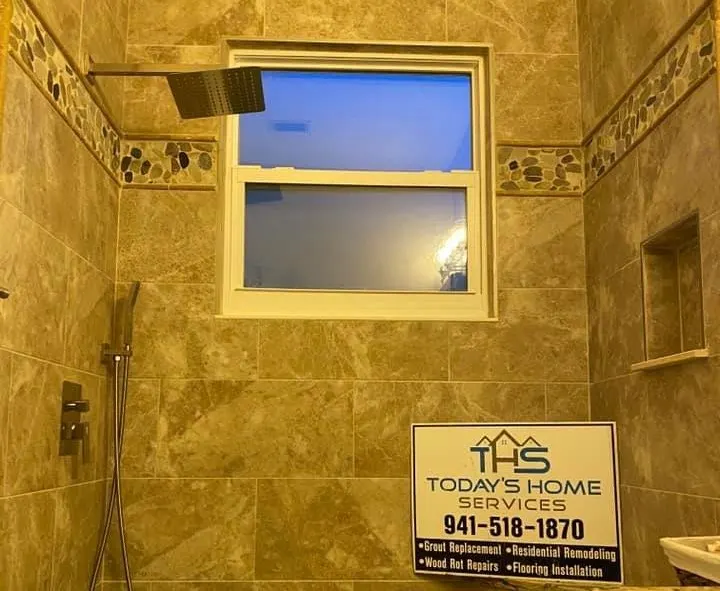 Shower with tan stone-look tile and window