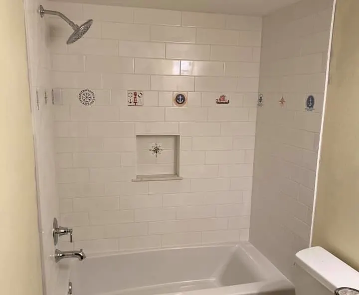 Tub and shower combination with white wall tile and recessed niche